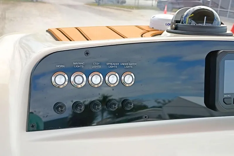 Slide: The Image of Control panel of 2026 Pioneer 202 Sportfish boat with various light switches. - 10