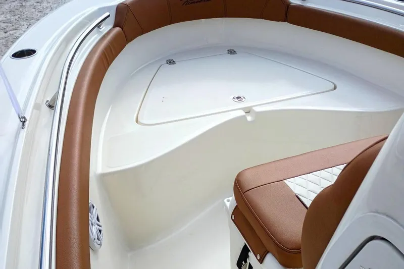 Slide: The Image of 2026 Pioneer 202 Sportfish boat interior with brown and white seating, showcasing modern design. - 14
