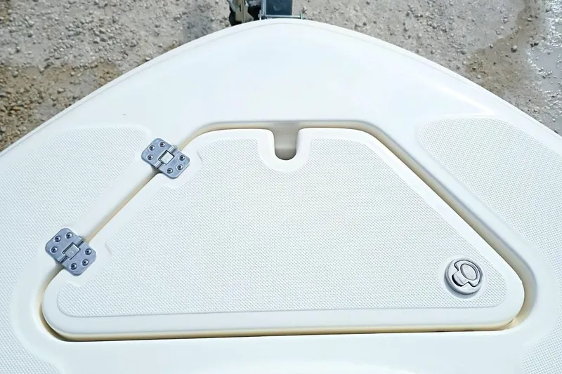 Slide: The Image of 2026 Pioneer 202 Sportfish boat hatch with hinges and textured surface. - 17