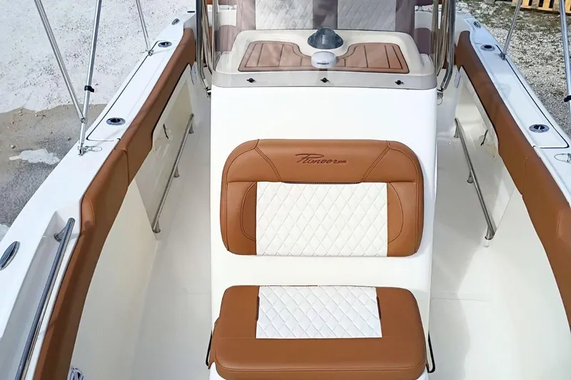 Slide: The Image of 2026 Pioneer 202 Sportfish boat interior with brown and white seating. - 21