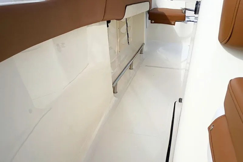 Slide: The Image of 2026 Pioneer 202 Sportfish interior with sleek white deck and brown seating. - 23