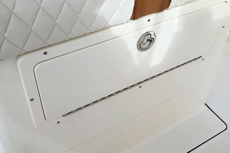 Slide: The Image of 2026 Pioneer 202 Sportfish boat storage compartment with quilted upholstery detail. - 27