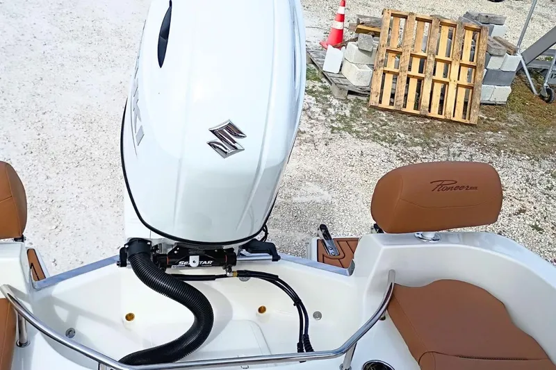 Slide: The Image of 2026 Pioneer 202 Sportfish boat with Suzuki outboard motor and brown seating. - 29