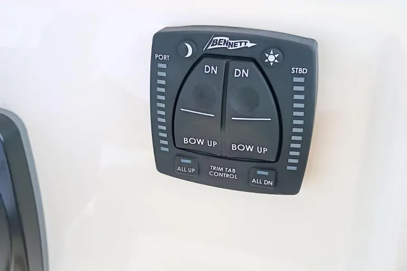 Slide: The Image of Bennett trim tab control on 2026 Pioneer 202 Sportfish boat dashboard. - 31