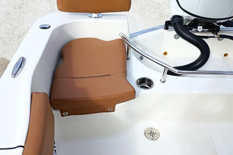 Slide: The Image of 2026 Pioneer 202 Sportfish boat interior with tan seating and stainless steel railing. - 32