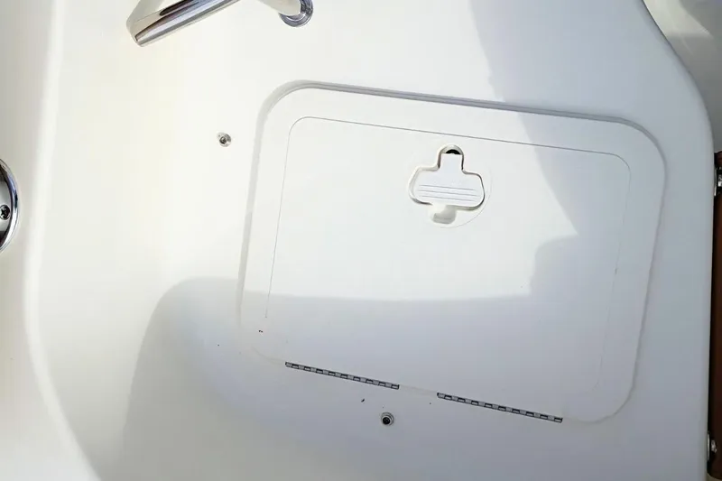 Slide: The Image of 2026 Pioneer 202 Sportfish boat hatch detail with stainless steel handle. - 33