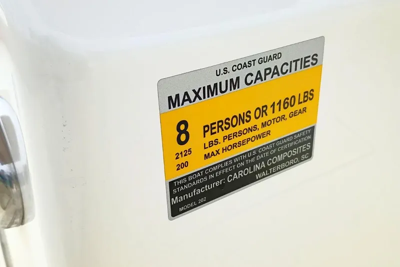 Slide: The Image of 2026 Pioneer 202 Sportfish capacity label, 8 persons or 1160 lbs, U.S. Coast Guard compliant. - 38