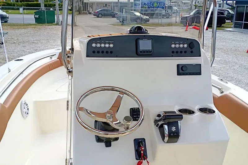Slide: The Image of 2026 Pioneer 202 Sportfish boat dashboard with steering wheel and control panel. - 40