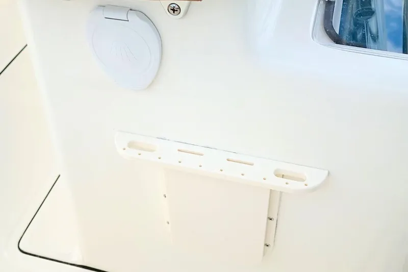 Slide: The Image of 2026 Pioneer 202 Sportfish boat detail, featuring a white panel and accessory mount. - 7