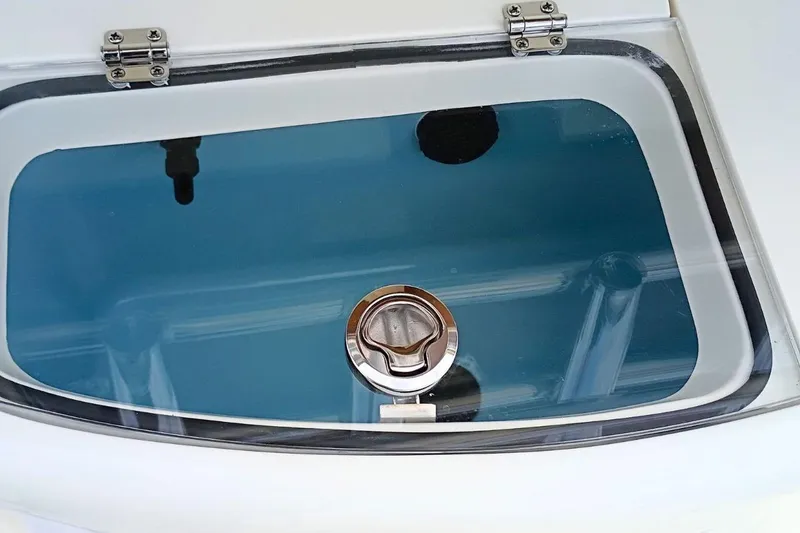 Slide: The Image of Livewell compartment on 2026 Pioneer 202 Sportfish boat, featuring a secure latch. - 8