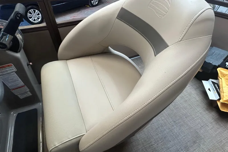 Slide: The Image of 2023 Sun Tracker Party Barge 18 DLX pontoon boat on trailer, parked outdoors. - 12