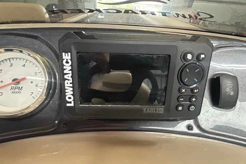 Slide: The Image of 2023 Sun Tracker Party Barge 18 DLX pontoon boat on trailer, parked on roadside. - 14