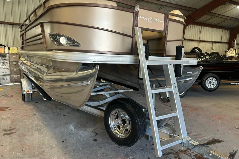 Slide: The Image of Close-up of a 2023 Sun Tracker Party Barge 18 DLX propeller on a trailer. - 22