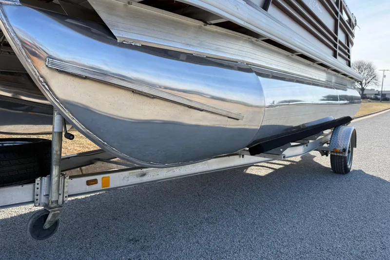 Slide: The Image of 2023 Sun Tracker Party Barge 18 DLX pontoon on trailer, side view. - 25