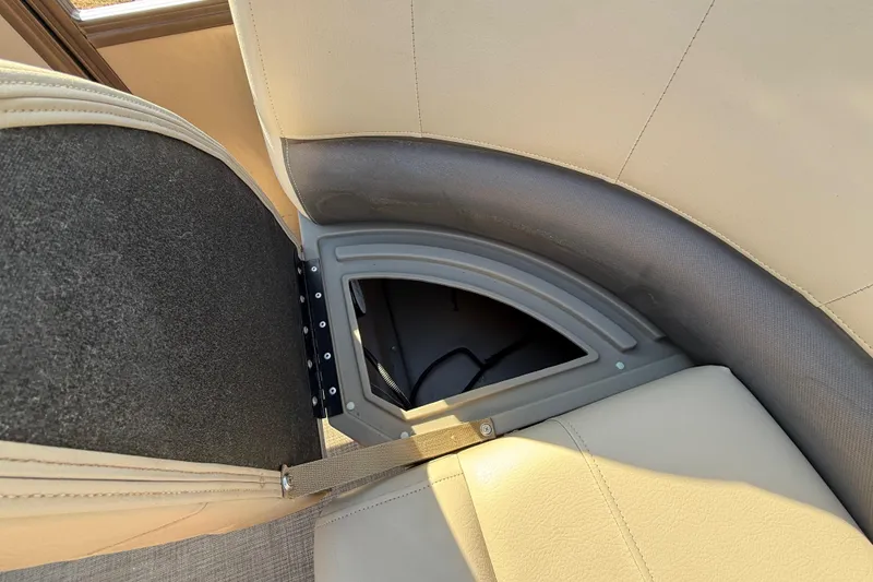 Slide: The Image of 2023 Sun Tracker Party Barge 18 DLX storage compartment with open seat cushion. - 38