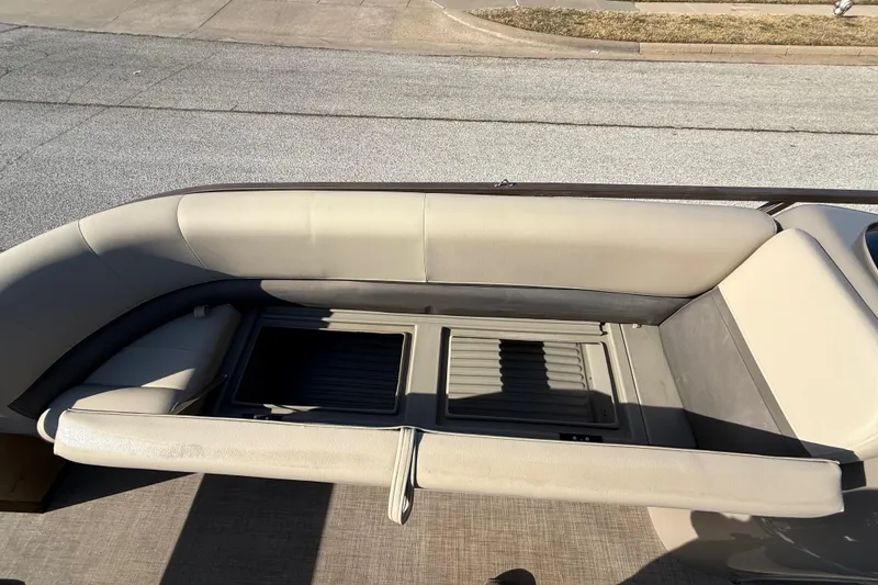 Slide: The Image of 2023 Sun Tracker Party Barge 18 DLX with beige seating and storage compartment. - 39