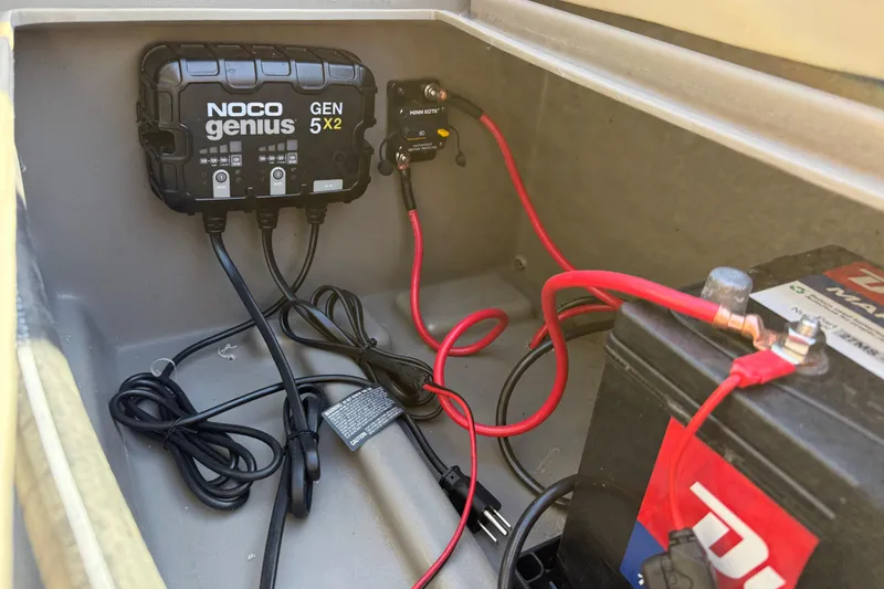 Slide: The Image of Battery compartment of 2023 Sun Tracker Party Barge 18 DLX with NOCO Genius GEN5X2 charger. - 46