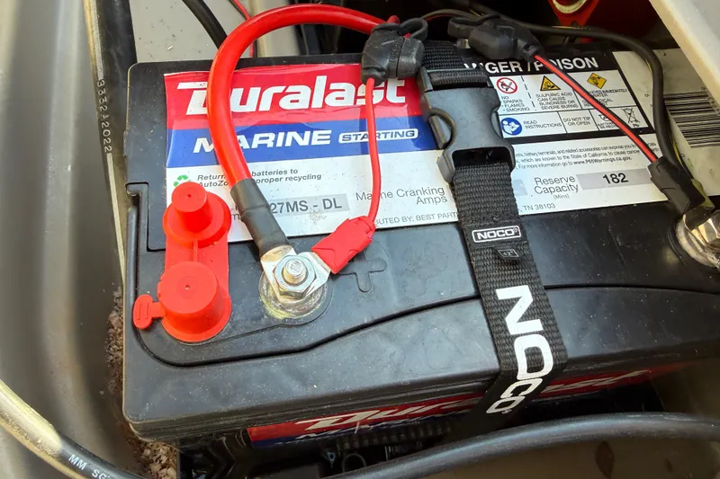 Slide: The Image of Marine battery in a 2023 Sun Tracker Party Barge 18 DLX, featuring Duralast branding. - 47