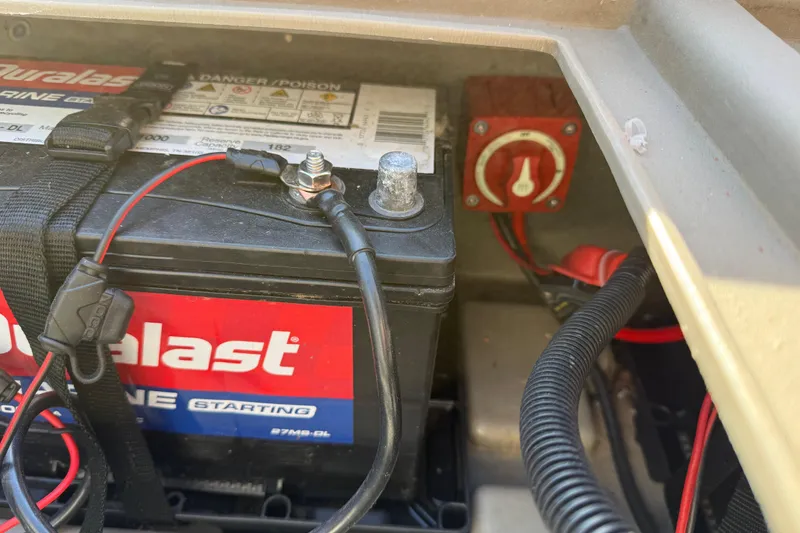 Slide: The Image of Battery compartment of 2023 Sun Tracker Party Barge 18 DLX with wiring and switch. - 48