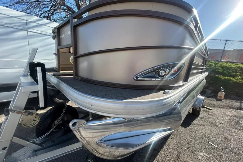 Slide: The Image of 2023 Sun Tracker Party Barge 18 DLX pontoon boat on trailer, parked outdoors. - 5