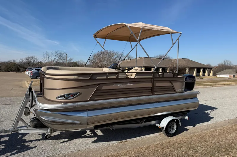 Slide: The Image of 2023 Sun Tracker Party Barge 18 DLX pontoon boat on trailer, parked outdoors. - 54