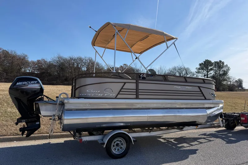 Slide: The Image of 2023 Sun Tracker Party Barge 18 DLX pontoon boat on trailer, with Mercury outboard motor. - 57