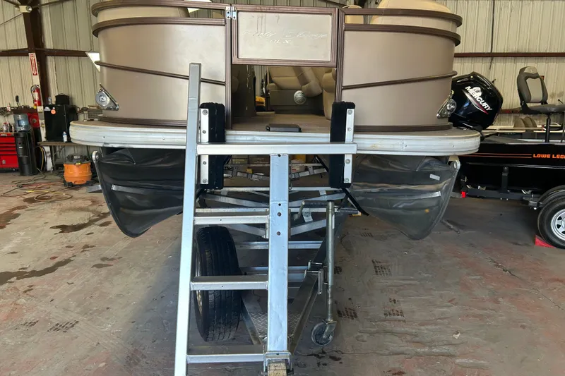 Slide: The Image of 2023 Sun Tracker Party Barge 18 DLX pontoon boat on trailer, outdoors. - 6