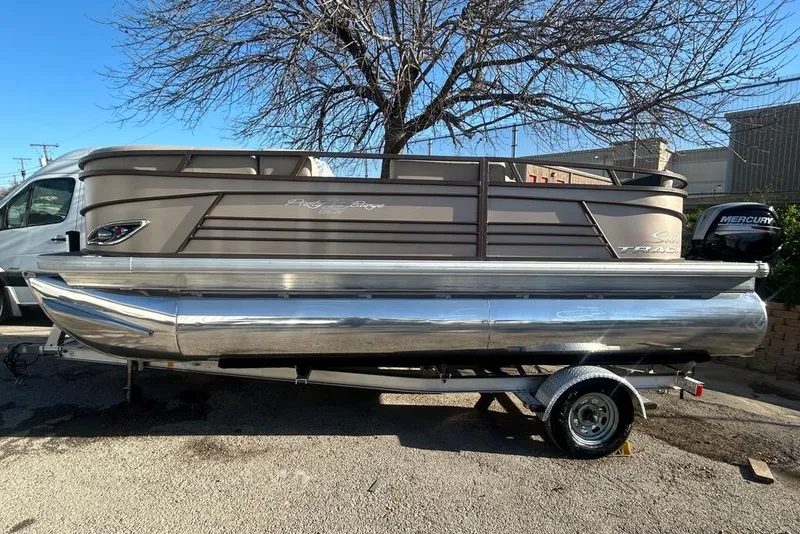 Slide: The Image of 2023 Sun Tracker Party Barge 18 DLX pontoon boat with Mercury outboard motor on trailer. - 7