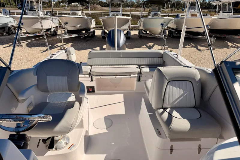 Slide: The Image of 2023 Sea Fox 228 Traveler boat interior with seating and steering wheel, displayed outdoors. - 10
