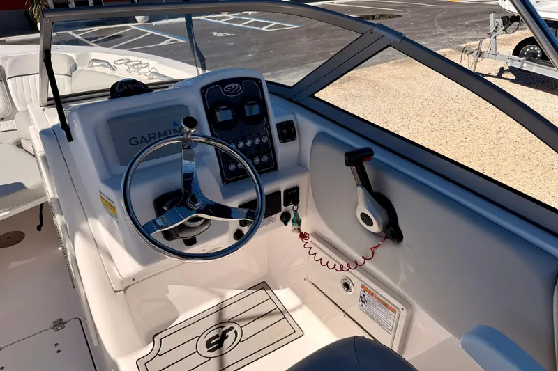 Slide: The Image of 2023 Sea Fox 228 Traveler boat dashboard with Garmin navigation system and steering wheel. - 13