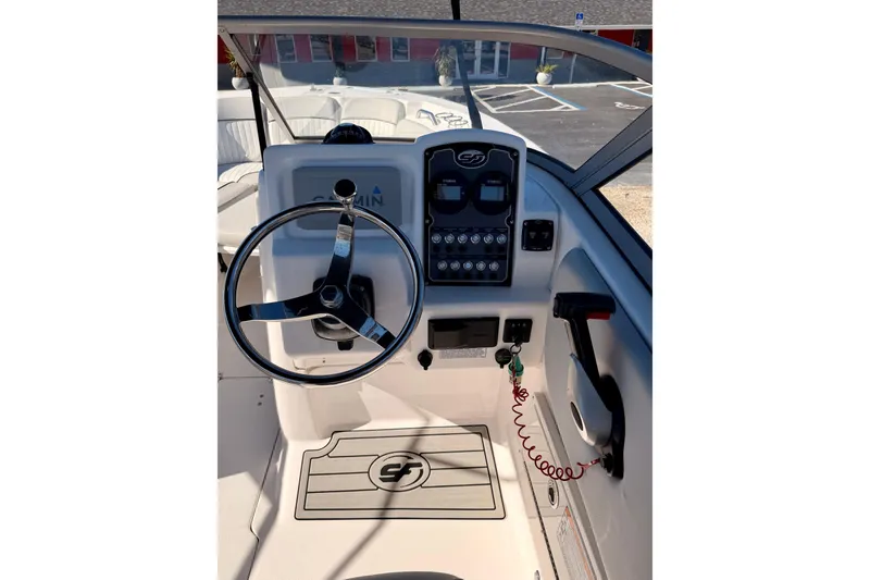 Slide: The Image of 2023 Sea Fox 228 Traveler boat helm with steering wheel and control panel. - 14