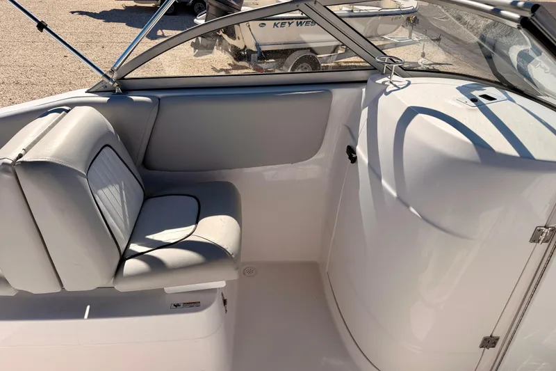 Slide: The Image of 2023 Sea Fox 228 Traveler boat interior with cushioned seating and storage compartment. - 19