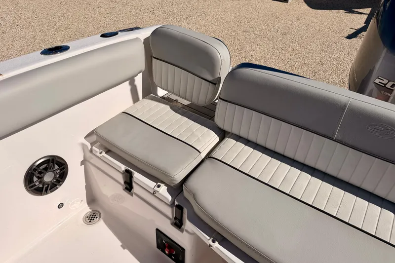 Slide: The Image of 2023 Sea Fox 228 Traveler boat interior seating with gray upholstery and speaker. - 28