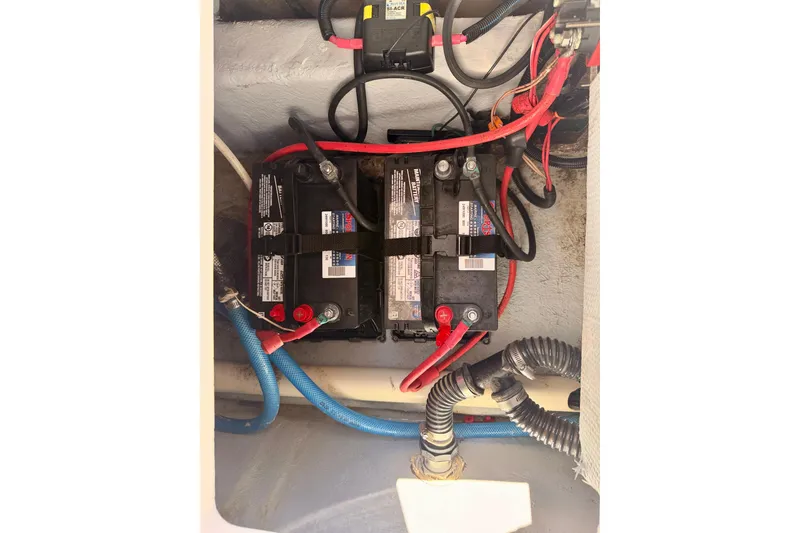Slide: The Image of 2023 Sea Fox 228 Traveler boat battery compartment with wiring and connections. - 37
