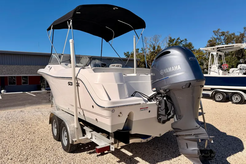 Slide: The Image of 2023 Sea Fox 228 Traveler boat with Yamaha engine on trailer, parked outdoors. - 6