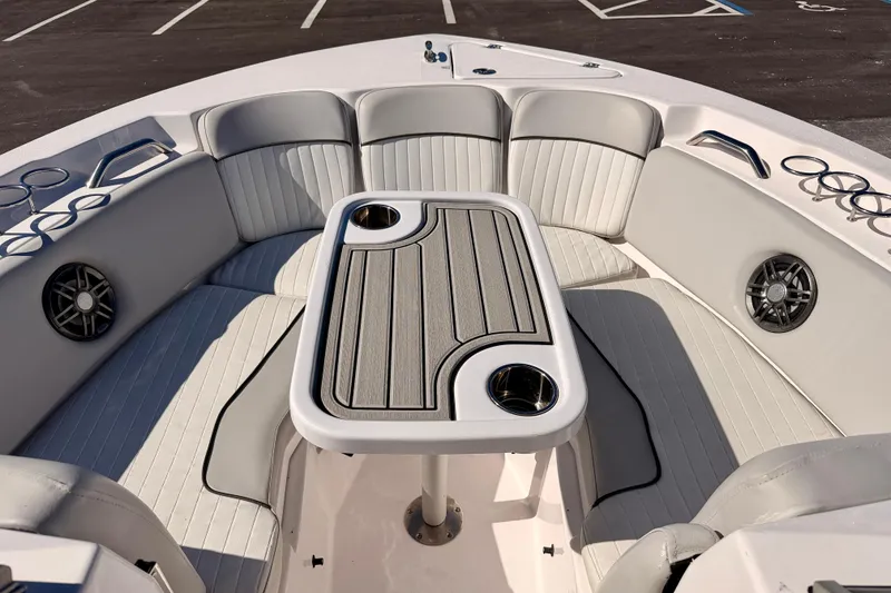 Slide: The Image of 2023 Sea Fox 228 Traveler boat interior with seating and table, featuring cup holders and speakers. - 9