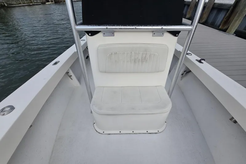 Slide: The Image of 2020 May-Craft 23 Cape Classic boat interior with seating and railing by the water. - 10