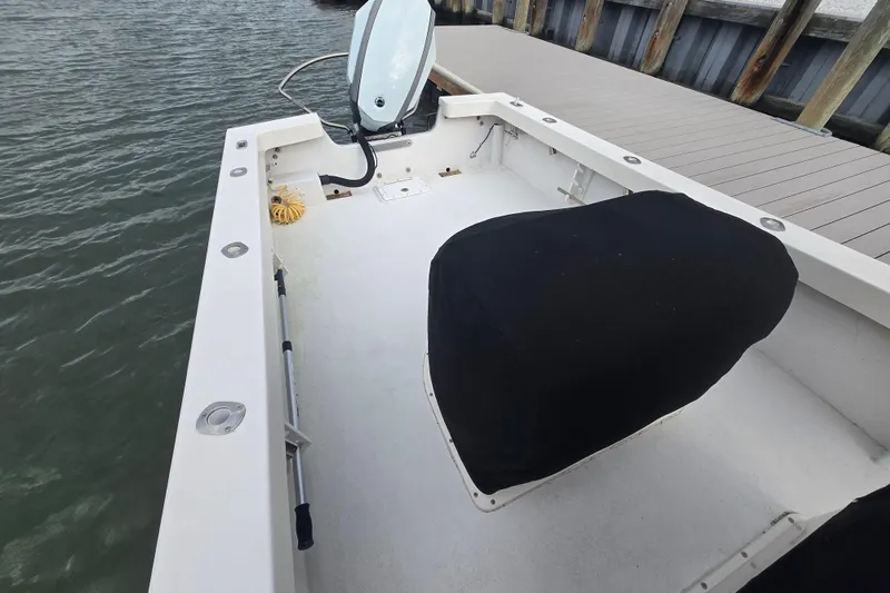 Slide: The Image of 2020 May-Craft 23 Cape Classic boat interior at dock, featuring covered seating and steering console. - 11