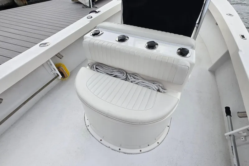 Slide: The Image of 2020 May-Craft 23 Cape Classic boat interior with white seating and rope. - 14