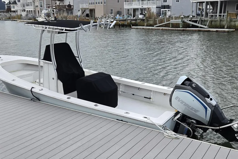 Slide: The Image of 2020 May-Craft 23 Cape Classic boat docked with Evinrude outboard motor. - 16