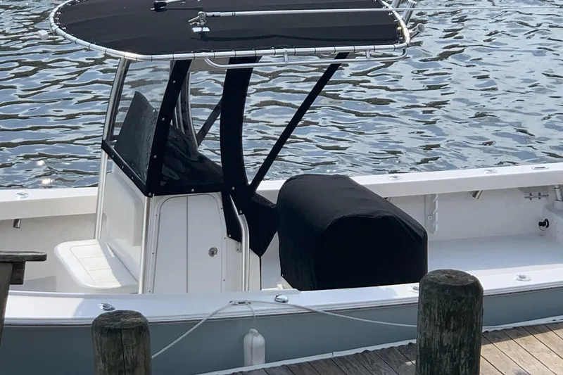 Slide: The Image of 2020 May-Craft 23 Cape Classic boat docked by the water. - 18