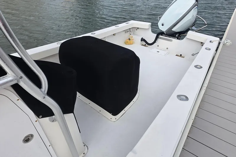 Slide: The Image of 2020 May-Craft 23 Cape Classic boat interior with covered seats and outboard motor. - 8