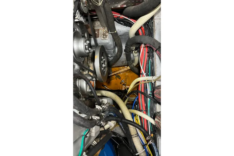 Slide: The Image of Engine compartment of a 2006 Tayana Cutter sailboat, showing belts and wiring. - 10