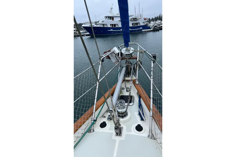 Slide: The Image of Bow view of 2006 Tayana Cutter sailboat in marina, with yacht in background. - 14
