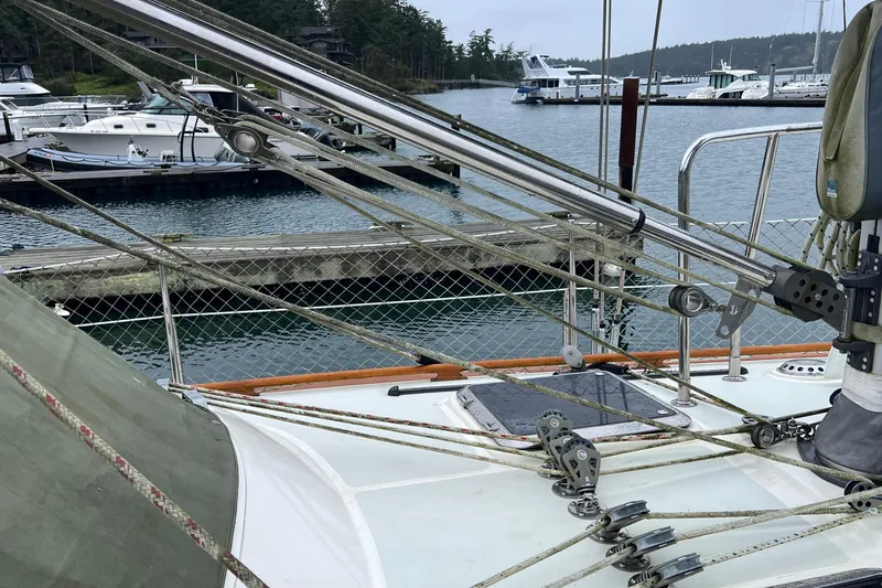 Slide: The Image of Deck view of a 2006 Tayana Cutter sailboat docked in a marina. - 15