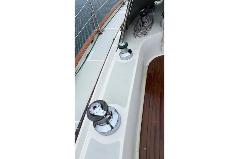 Slide: The Image of 2006 Tayana Cutter sailboat deck with winches and wooden flooring. - 17