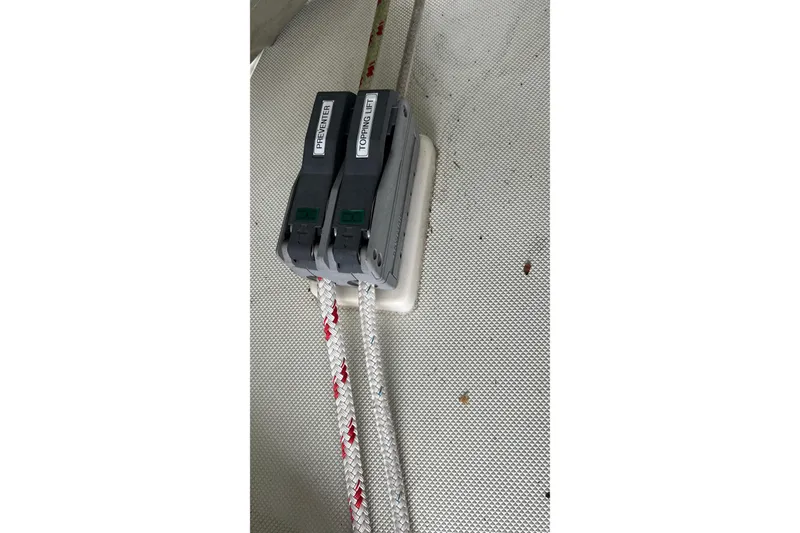 Slide: The Image of Close-up of rope clutches labeled "Preventer" and "Topping Lift" on 2006 Tayana Cutter. - 20