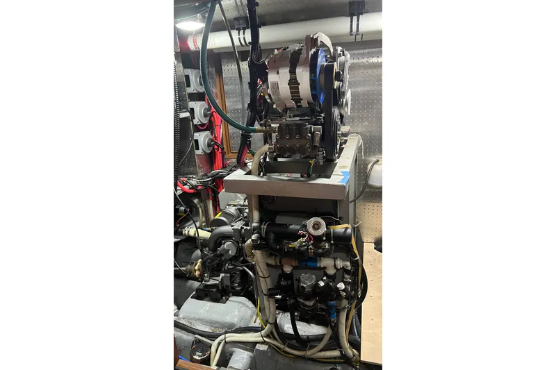 Slide: The Image of Engine room of a 2006 Tayana Cutter sailboat with visible machinery and wiring. - 27