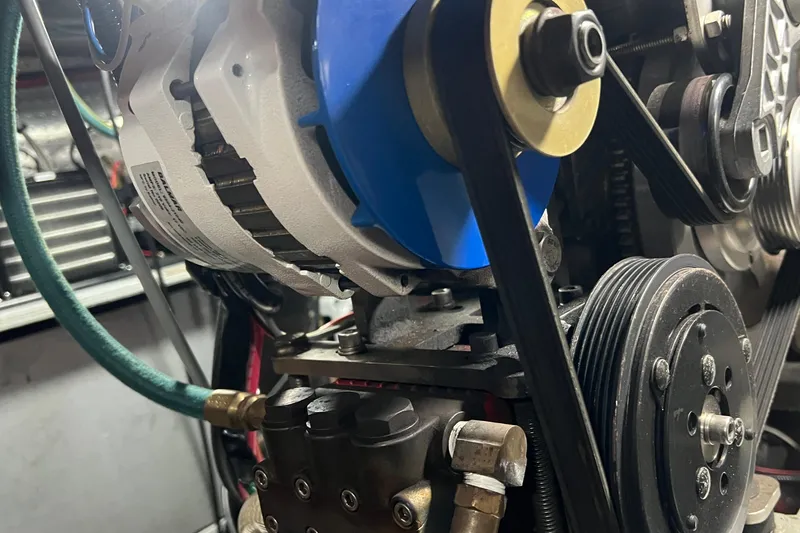 Slide: The Image of Close-up of a 2006 Tayana Cutter engine component with belts and pulleys. - 30