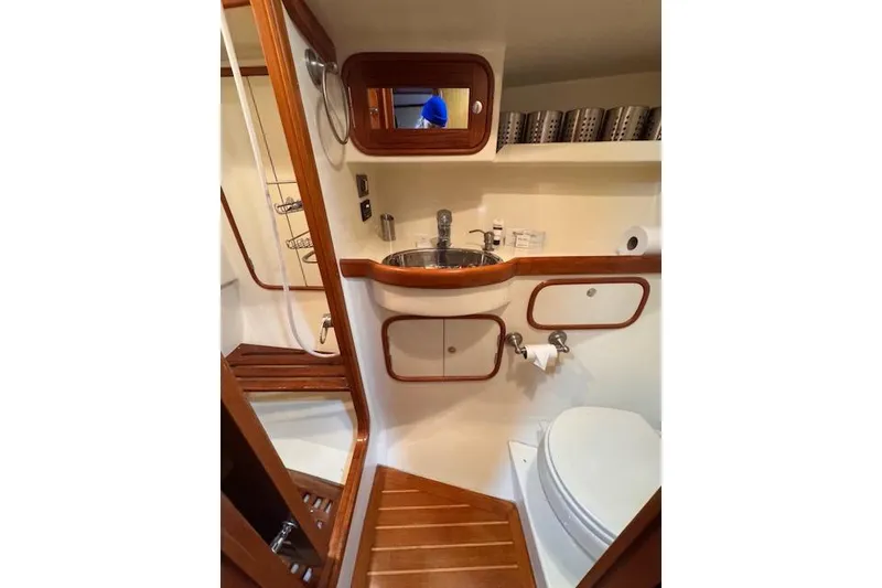 Slide: The Image of 2006 Tayana Deck Salon yacht bathroom with wooden accents and modern fixtures. - 8
